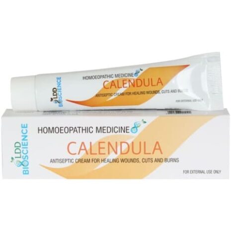 A tube of Calendula antiseptic cream placed on its box, labeled as homoeopathic medicine for healing wounds, cuts, and burns.