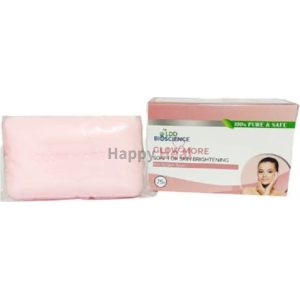 A pink bar soap with packaging that promotes skin brightening, featuring the text "Glow More" and an image of a smiling woman.