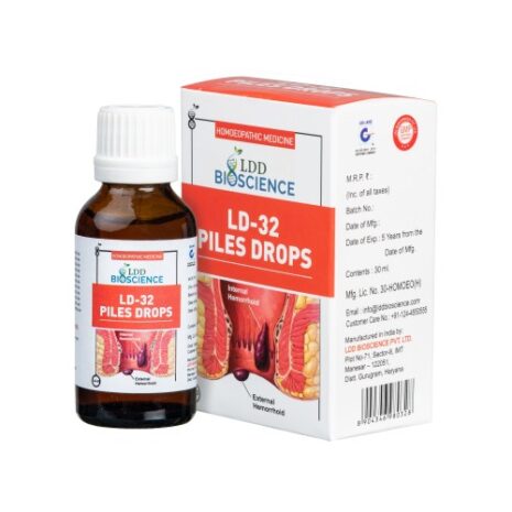 A bottle of LD-32 Piles Drops alongside its packaging, designed for treating internal and external hemorrhoids, featuring an illustration of the human digestive system.