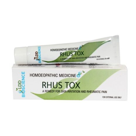 A tube of Rhus Tox homeopathic medicine for skin irritation and rheumatic pain, placed beside its packaging.
