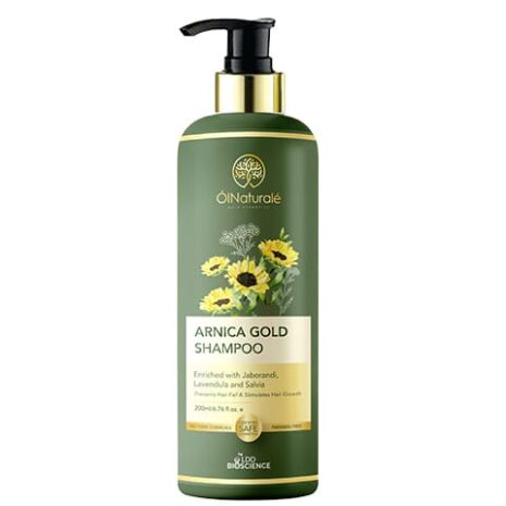 A green bottle of Arnica Gold Shampoo featuring sunflower graphics, designed to prevent hair fall and promote scalp health.
