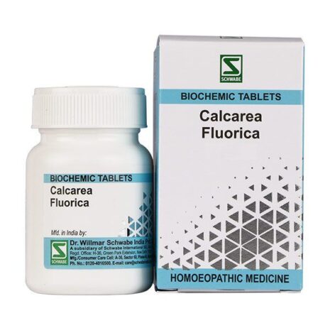 A container of Calcarea Fluorica biochemic tablets alongside its packaging, labeled as homeopathic medicine.