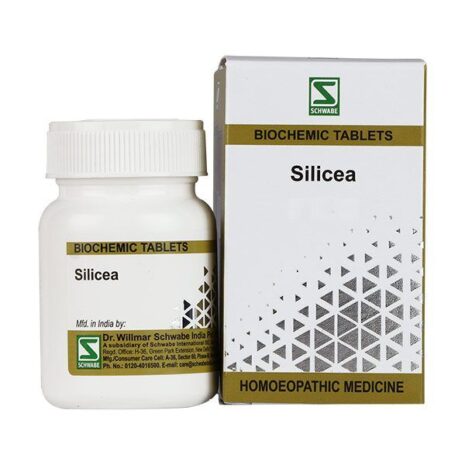 A bottle of Silicea biochemic tablets alongside its packaging, featuring a white design with geometric patterns and branding for Dr. Willmar Schwabe India.