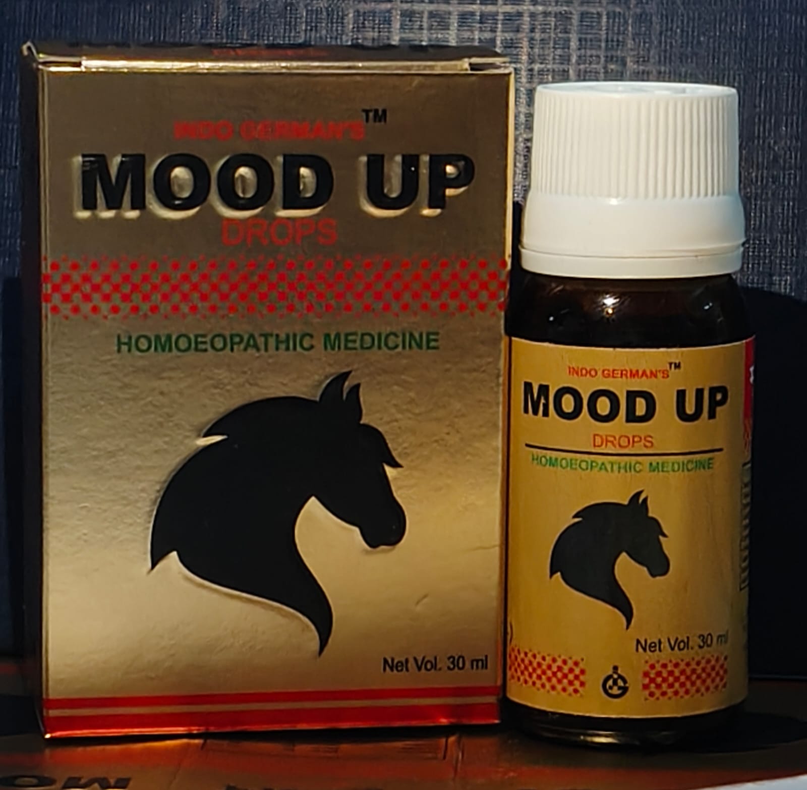Bottle and packaging of Indo German's Mood Up homeopathic medicine in a gold design featuring a horse silhouette.